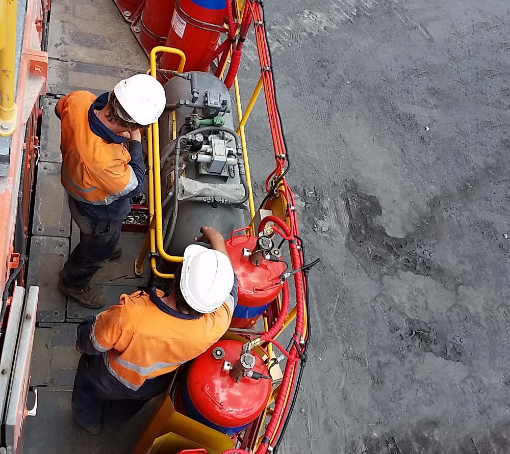 Qtec Fire Services employees and workers working on spray systems and equipment.